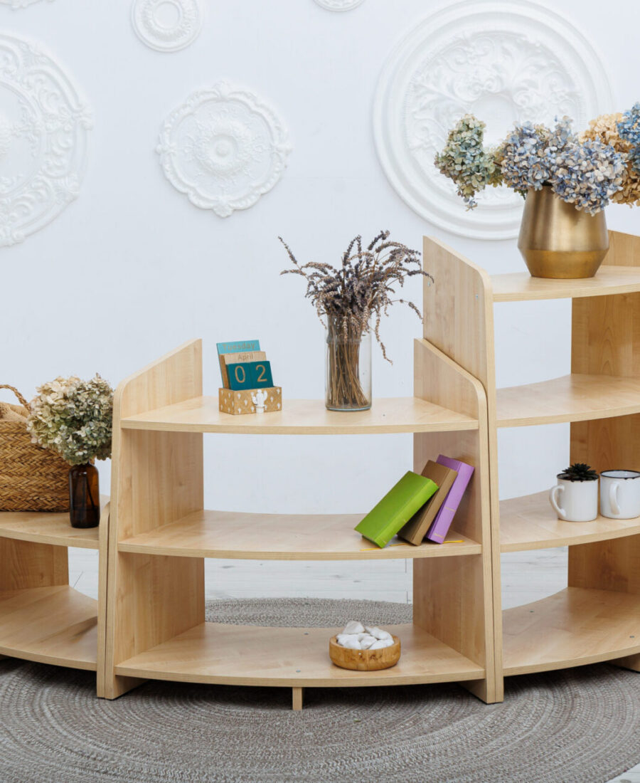 A wooden shelf with a lovely vase of flowers on top